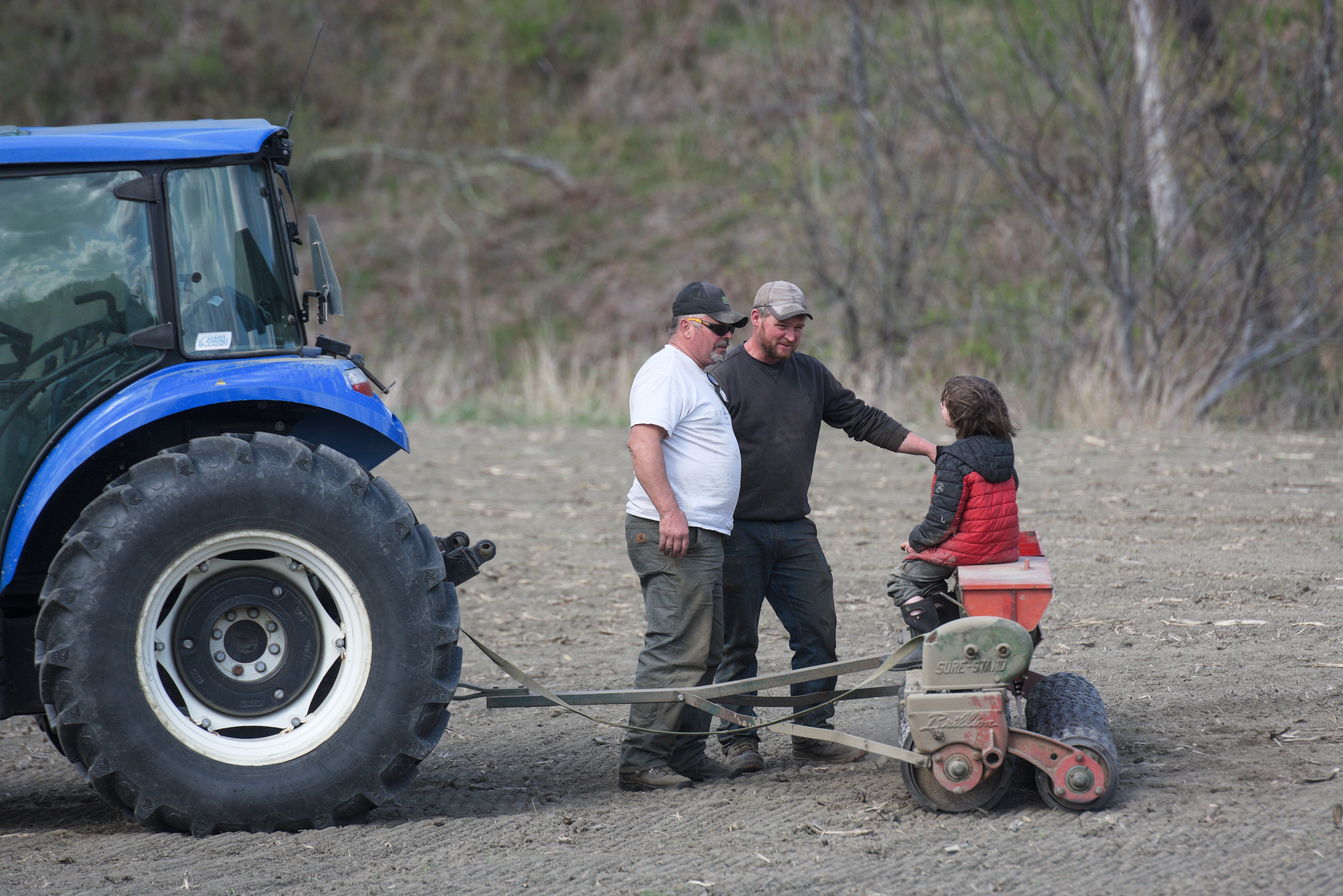 Young farm helper inspects seeder’s performance in Royalton